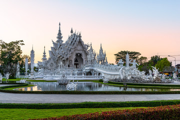 Wat Rong Khun(White temple)at sunset in Chiang Rai,Thailand.23/01/2018 Wat Rong Khun is modern building, well known worldwide.It was designed by Chalermchai Kositpipat.Opened it to visitors in 1997.