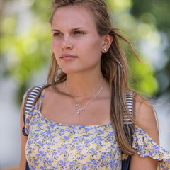  Beautiful girl in the street. Young female model standing waiting for a bus.
