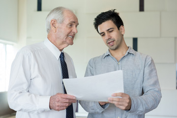 Two Businessmen Inspecting Document