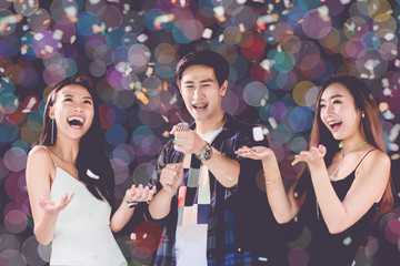 celebration party group of Two asian young man and women people holding confetti happy and funny...