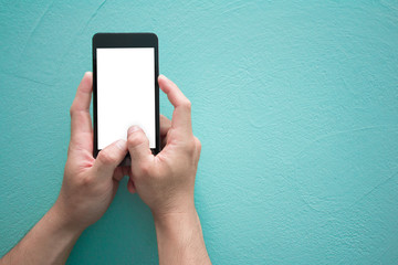 Close-up, hand using Smartphone digital . Blank screen mobile phone for Your text message, Graphics Display isolated on green background.