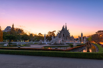 Wat Rong Khun(White temple)at sunset in Chiang Rai,Thailand.23/01/2018 Wat Rong Khun is modern building, well known worldwide.It was designed by Chalermchai Kositpipat.Opened it to visitors in 1997.