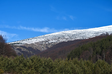 Mountain landscape and country road on clear sunny winter day