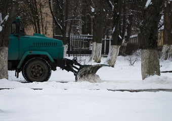 Snow plow removing snow from city road