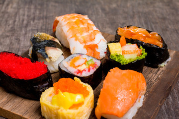 Top view,Sushi Set sashimi and sushi rolls served on wood slate.Copy space for your text.