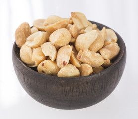 Toasted peanuts on wooden background - Arachis hypogaea