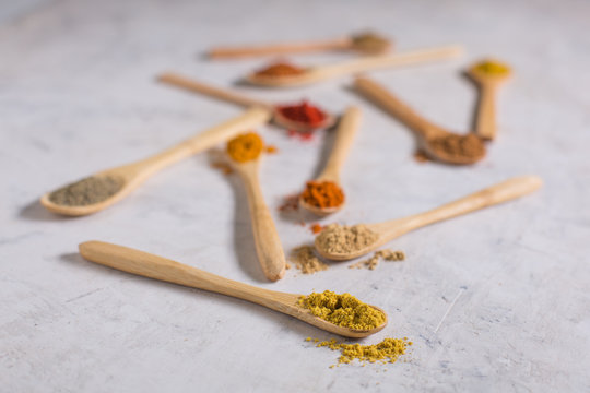 Different spices in wooden spoons