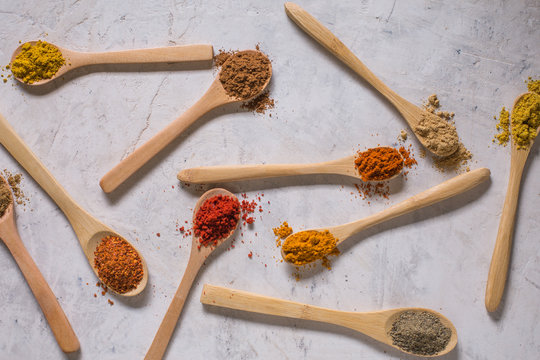 Different spices in wooden spoons