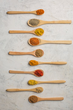 Different spices in wooden spoons