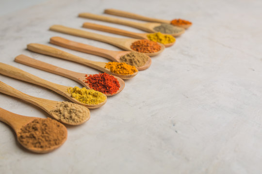 Different spices in wooden spoons