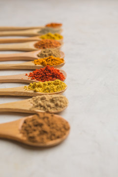 Different spices in wooden spoons