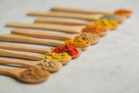 Different spices in wooden spoons