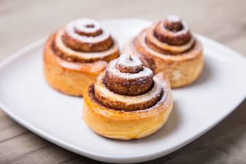 Obraz na płótnie Canvas Fresh homemade buns with cinnamon. Selective focus, close-up.