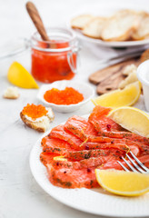 Delicious lunch with salted salmon, red caviar, fresh bread and cream cheese