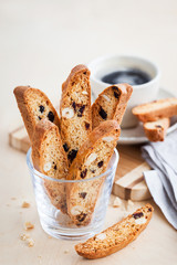 Italian cranberry almond biscotti  and cup of coffee on background