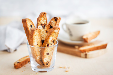 Italian cranberry almond biscotti  and cup of coffee on background - obrazy, fototapety, plakaty