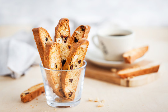 Italian cranberry almond biscotti  and cup of coffee on background