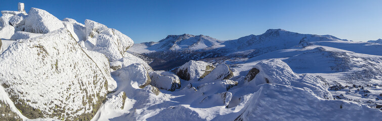 Winter mountain landscape overlooking the of the forest valley. Panoramic photo.