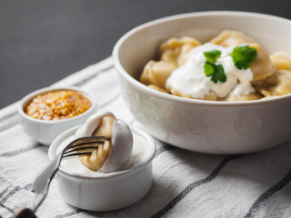 Dumplings on plate at wooden desk on black background