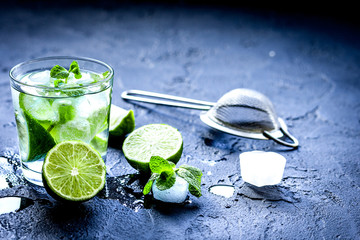mojito in glass on dark background close up