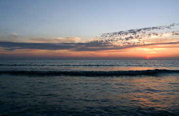Laesoe / Denmark: Dreamlike sunset with orange-red glowing sky over the Baltic Sea between Laesoe and the Danish mainland