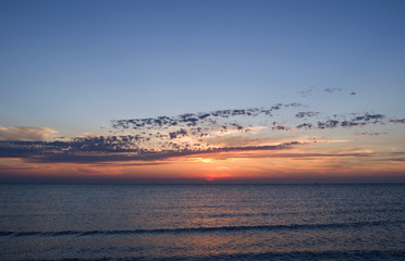 Laesoe / Denmark: Dreamlike sunset with orange-red glowing sky over the Baltic Sea between Laesoe and the Danish mainland