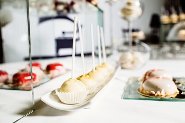 Wedding reception dessert table with delicious decorated white c