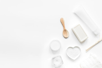 white set of cosmetics for spa on table background top view mock
