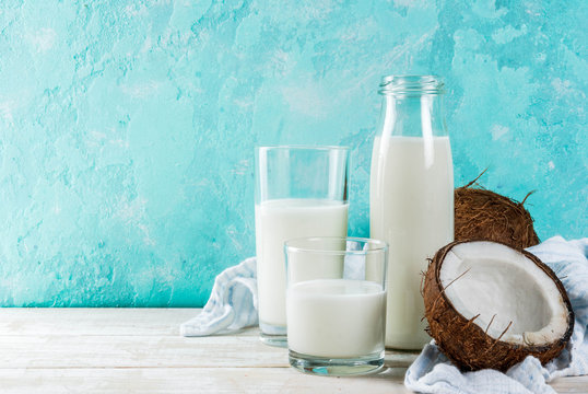 Vegan alternative food, coconut non-dairy milk on light blue background, copy space