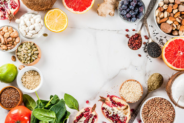 Set of organic healthy diet food, superfoods - beans, legumes, nuts, seeds, greens, fruit and vegetables.. white background copy space. top view frame