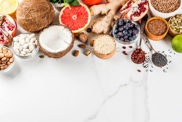 Set of organic healthy diet food, superfoods - beans, legumes, nuts, seeds, greens, fruit and vegetables.. white background copy space. top view