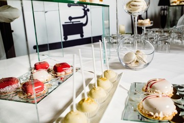 Wedding reception dessert table with delicious decorated white c