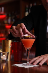 barman preparing a passion fruit cocktail
