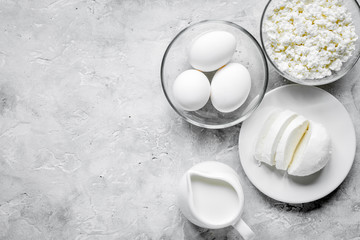 Fresh dairy products on stone table background top view mock up