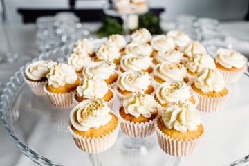 Wedding reception dessert table with delicious decorated white c