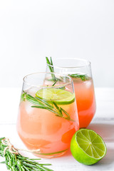 healthy morning with fresh drink, lime and rosemary on white tab