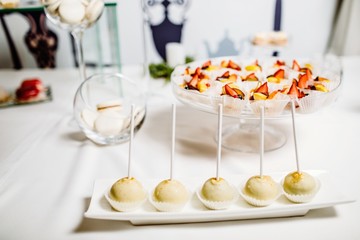 Wedding reception dessert table with delicious decorated white c