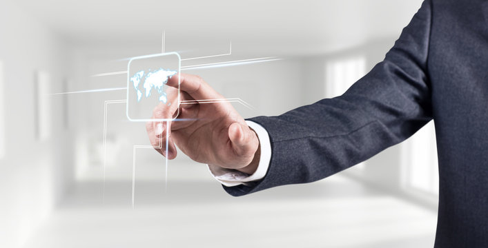 Businessman's hand touches glowing world map.