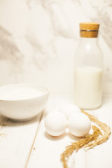 Obraz na płótnie Canvas Cooking Homemade Spaghetti with eggs, flour, milk on a white wooden table, selective focus