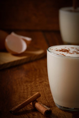 Eggnog houmemade with cinnamon and kakao for Christmas and winter holidays or wooden broun backgrounds