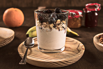 Healthy food,yogurt,blueberries,blackberries,jam,nuts,cereals and fruit. Nutritious breakfast