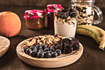 Healthy food,yogurt,blueberries,blackberries,jam,nuts,cereals and fruit. Nutritious breakfast
