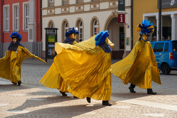 Four persons dressed in nice Venetian carnival costumes on Ash Wednesday in the city centre of...