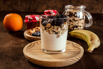 Healthy food,yogurt,blueberries,blackberries,jam,nuts,cereals and fruit. Nutritious breakfast