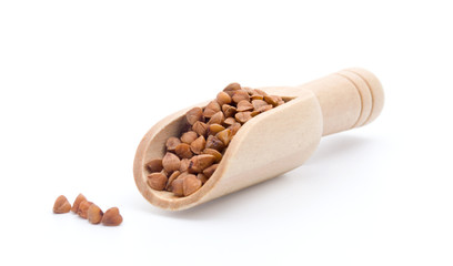 wooden scoop with buckwheat isolated on white background