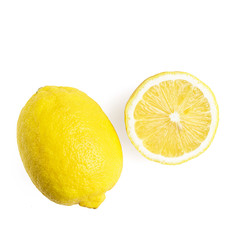 One whole and half of yellow ripe lemon fruit, isolated on a white background, top view