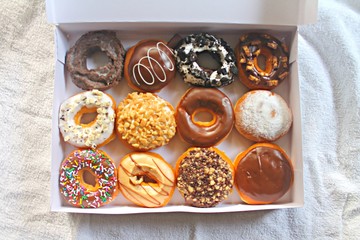 Variety Colorful Donuts Food in a White Box Top View 
