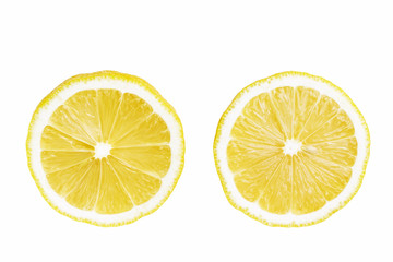Two round slices of yellow ripe lemon fruit, isolated on a white background, top view