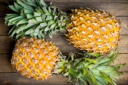 Fresh ripe pineapples on the rustic background. Selective focus.