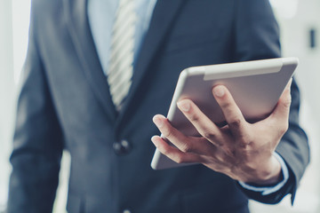 Businessman use computer tablet for work in communication around worldwide to success marketing plan of company